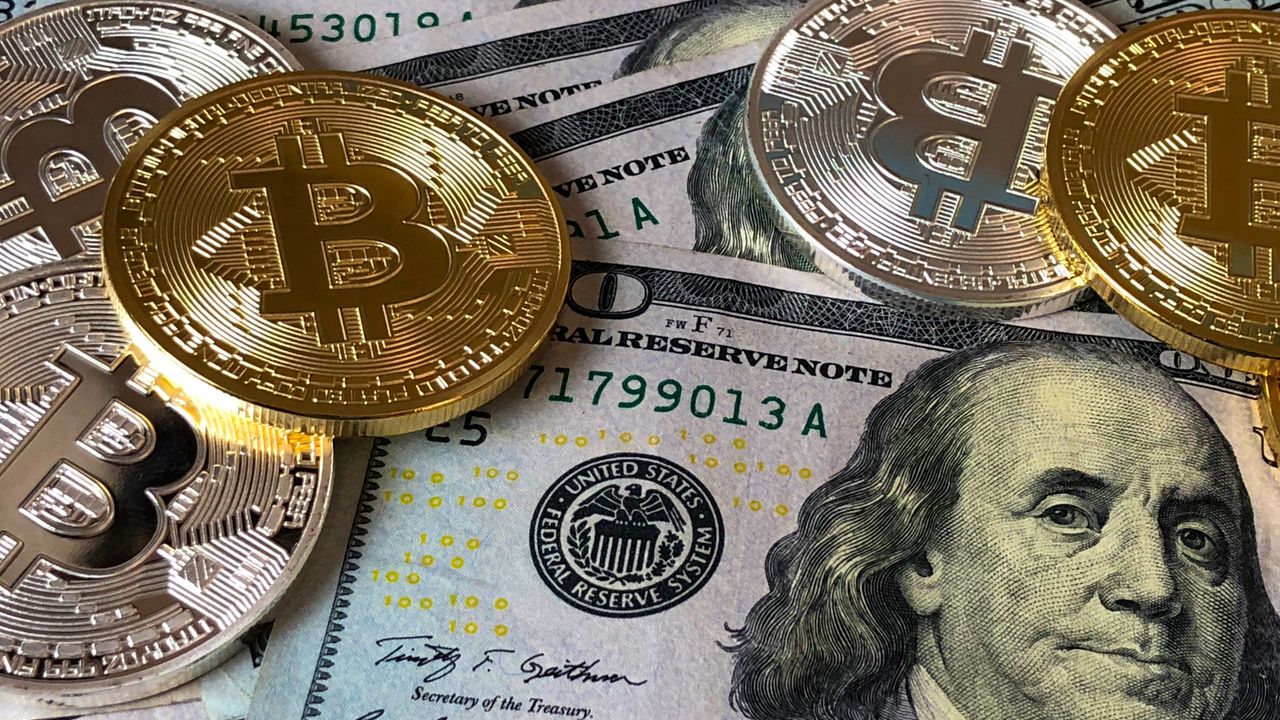 Coins resting on a spread of banknotes